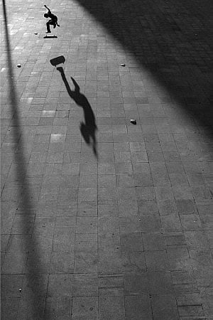 skateboarder jumping with shadow